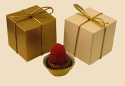 Raspberry Royale | 1-piece box - Dark chocolate is blended with dark chocolate ganache and European raspberry preserves to create our newest confection.  Offered in a chocolate cup and topped with a fresh raspberry.  Packed in a one-piece box and personalized with your choice of message on a minimum order of fifty boxes.
